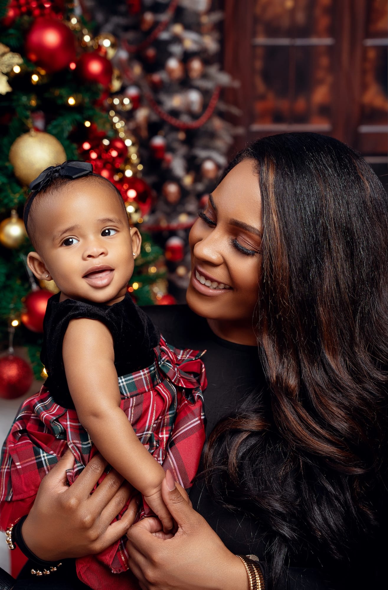 Mother and baby in elf hats during a cozy Christmas photo session